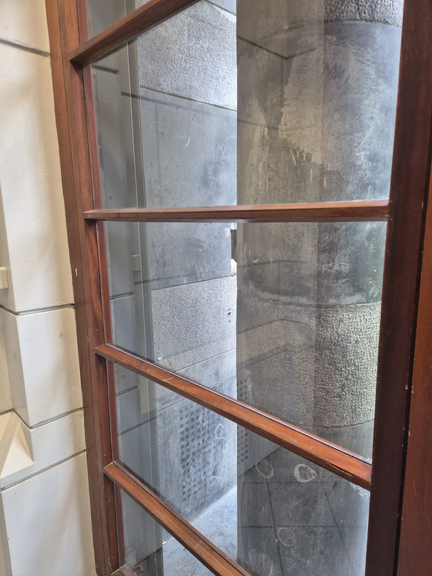After: replacement glass panel fitted in the existing timber door, viewed from inside