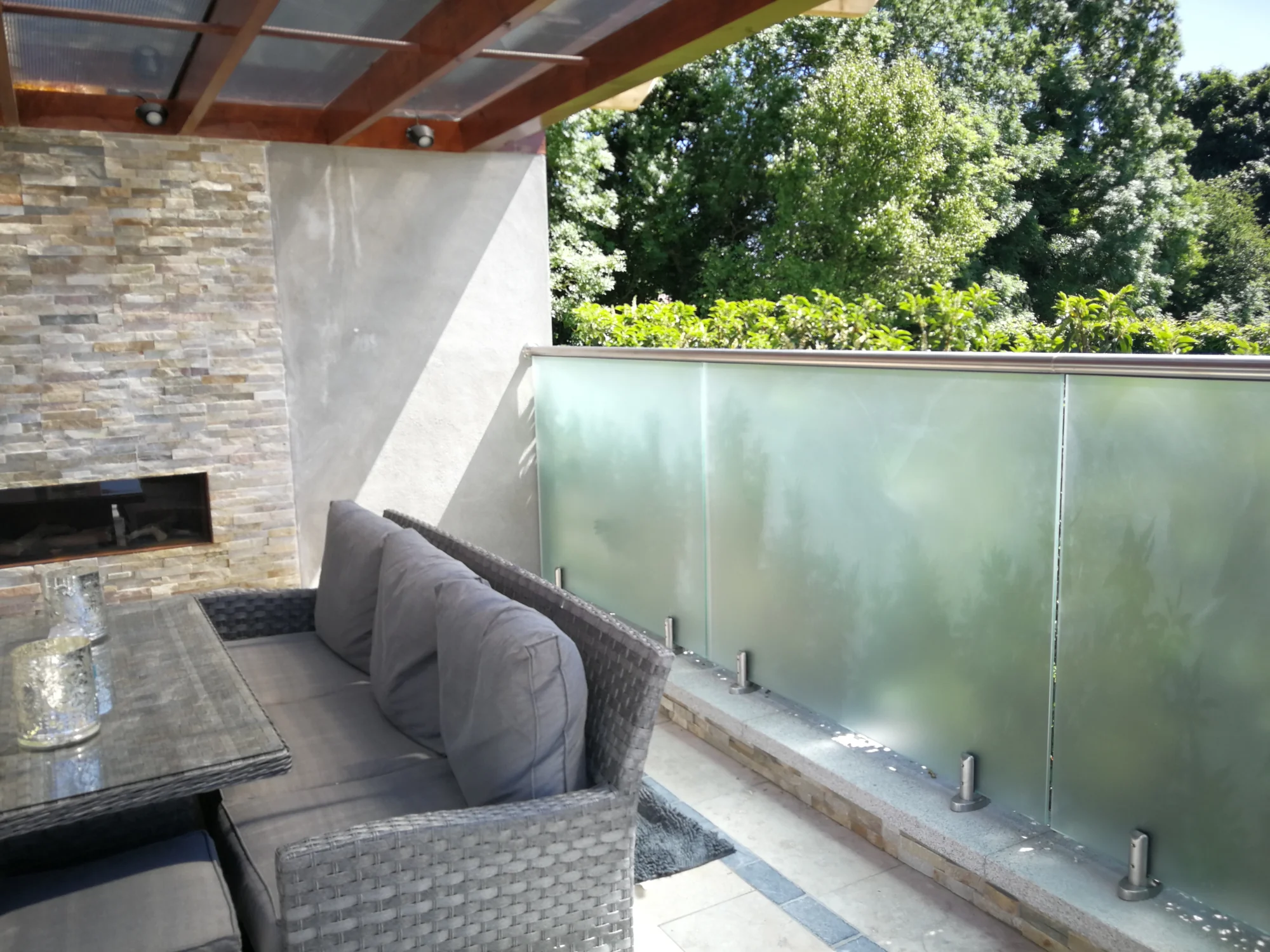 Frosted glass privacy balustrade beside outdoor seating in Garristown